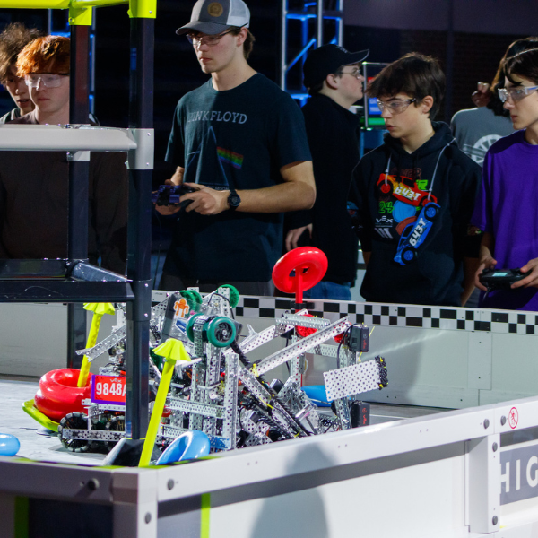 High school students operate robots during a VEX Robotics competition match